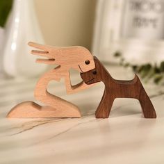 a wooden toy dog and cat on a table