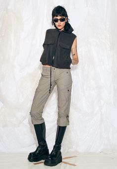 With a sporty coquette vibe and a low waist fit, these Y2K cargo capri pants are the perfect blend of funky and functional. Recommended size: EU 36-38 Features: - six pockets - zip closure Every item we manage is cleaned and, when necessary, repaired, ensuring it arrives to you in top condition. Our model, Noemi is 177 cm / 69.0" tall and she's a size S. Size: M / US 6 / UK 10 / IT 42 Measurements:  waist (seam to seam): 41 cm / 16.0" rise: 20 cm / 7.8" inseam length: 56 cm / 21.8" Care: Machine Y2k Mid-rise Cargo Pants For Streetwear, Y2k Winter Bottoms With Pockets, Y2k Style Cargo Pants With Pockets For Fall, Fitted 90s Style Cargo Pants For Streetwear, 90s Style Fitted Cargo Pants For Streetwear, 90s Fitted Cargo Pants For Streetwear, Y2k Parachute Pants With Cargo Pockets For Streetwear, Y2k Fitted Cargo Pants For Fall, Stretch Mid-rise Parachute Pants With Cargo Pockets