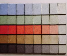 a wall with many different colored squares on it