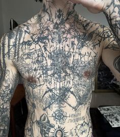 a man with lots of tattoos on his body