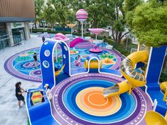 children's play area in the middle of a park with slides and water toys