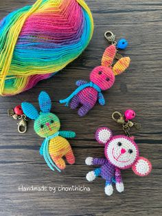 three crocheted keychains are sitting next to each other on a table