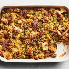 a casserole dish filled with stuffing and vegetables