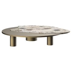 a white marble table with gold legs and an oval shaped center piece on the top