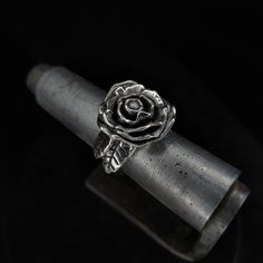 A beautiful sterling silver polished metal rose ring, blossoming on a finger is sure to grabb attention anywhere it is seen. Grab this pretty artefact for your goth girlfriend, mother or anyone who is into flowers and likes 3d metal sculptures.  Cast out of sterling silver as a single piece of metal, this ring has no joints or soldered parts, it is strong and durable.  Any finger size is available, as well as all sorts of customizations, contact me via Etsy messages for any further information. Silver Ring With Rose Design, Silver Wedding Ring With Roses, Rose Design Promise Jewelry, Silver Rings With Rose Design For Gift, Silver Floral Jewelry With Rose Design, Silver Flower Jewelry With Rose Design, Silver Rose Design Jewelry For Promise Ring, Silver Promise Ring With Roses Detail, Silver Flower Ring With Roses For Wedding