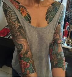 a woman with tattoos on her arms and shoulder