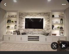 a living room with built in shelves and a flat screen tv mounted on the wall