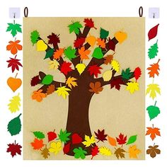 an autumn tree made out of leaves on a bulletin board