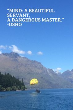 a large body of water with mountains in the background and a quote on it that reads, mind a beautiful servant, a dangerous master - osho