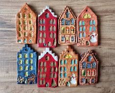 small ceramic houses are sitting on a table together in the shape of christmas townes