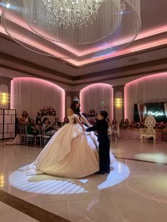 the bride and groom are getting ready to perform their first dance in front of an audience