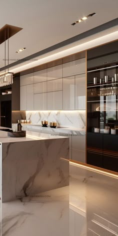 a modern kitchen with marble counter tops and white cabinets, along with chandelier lights