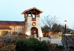 a clock tower in front of a house at dusk