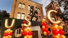 the letters u and u are made out of balloons in front of an old building