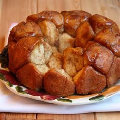 a bundt cake sitting on top of a white and yellow plate next to a wooden table