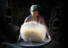 a woman is sprinkled with sand in the dark