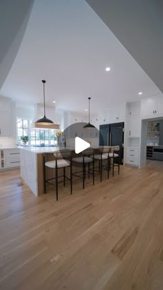 an open kitchen and dining room with hardwood floors