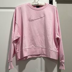 Nike Women’s Crop Sweatshirt Nike Casual Spring Sweater, Nike Spring Sweatshirt For Loungewear, Nike Crew Neck Top With Ribbed Cuffs, Nike Long Sleeve Tops For Loungewear, Pink Nike Tops For Winter, Trendy Nike Long Sleeve Sweatshirt, Spring Nike Crew Neck Sweatshirt, Nike Long Sleeve Tops With Ribbed Cuffs, Nike Oversized Long Sleeve Top