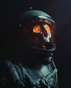 a man in a space suit with a skull on it's face and wearing a helmet