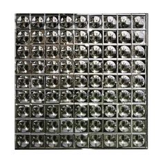 an image of a metal grid with many faces on it's side and one face in the middle