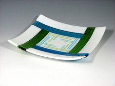 a white plate with green and blue strips on it