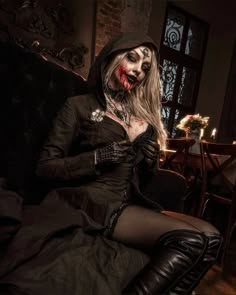 a woman dressed as a zombie sitting on a couch