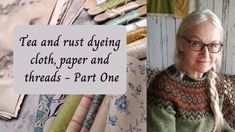 an older woman sitting in front of a pile of fabrics with a quote on it