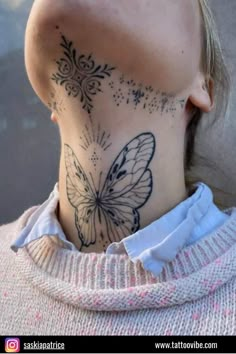 a woman with a butterfly tattoo on her neck