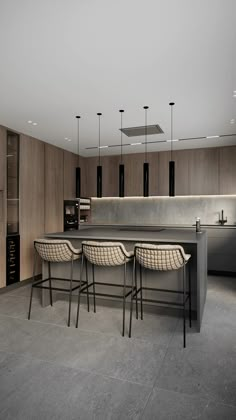 three chairs are sitting at the bar in this modern kitchen