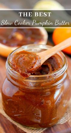 the best slow cooker pumpkin butter recipe in a glass jar with a wooden spoon