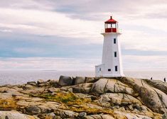 a light house sitting on top of a rocky shore