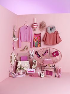 a pink advertisement with clothes and accessories on it