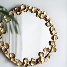 a mirror that has some gold flowers on it