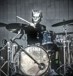 a man is playing drums on stage