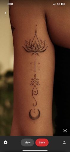 a woman's arm with a lotus tattoo on it and an arrow in the middle