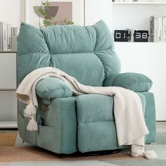 a blue recliner chair with a blanket on it's back in a living room