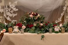 the table is covered with flowers and candles