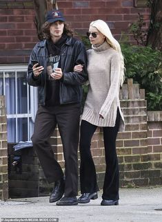 a man and woman walking down the street