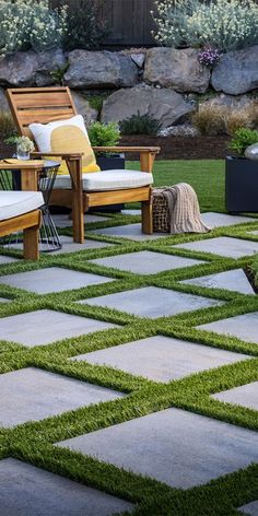 an outdoor patio with grass and wooden furniture