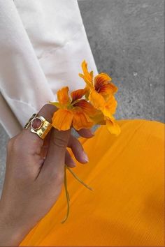 a person holding flowers in their hand