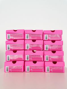 many pink boxes stacked on top of each other