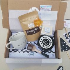 an open box containing coffee, cookies and other items