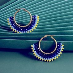 Gold Hoop Earrings With Fanned Seed Beads. Blue Beaded Round Hoop Earrings, Yellow Beaded Hoop Earrings For Summer, Yellow Beaded Hoop Earrings, Yellow Dangle Hoop Earrings With Colorful Beads, Yellow Colorful Beaded Hoop Earrings, Blue Hoop Earrings For Summer Festivals, Yellow Beaded Small Hoop Earrings, Small Yellow Beaded Hoop Earrings, Blue Small Hoop Beaded Earrings With Dangling Beads