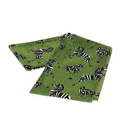 two green place mats with zebras on them