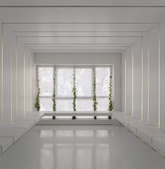 an empty room with white walls and windows