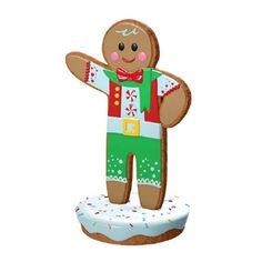 a gingerbread man standing on top of a frosted cake