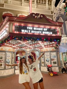 two girls are posing in front of the magic of walt world