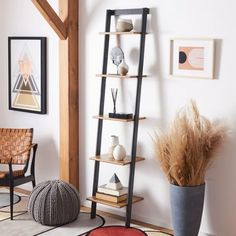 a living room with a rug, chair and bookcase on the floor in front of it