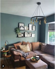 a living room filled with furniture and pictures on the wall