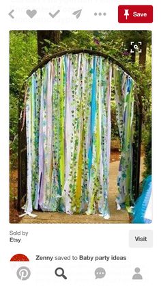 an outdoor wedding ceremony in the woods with colorful drapes and streamers draped over it